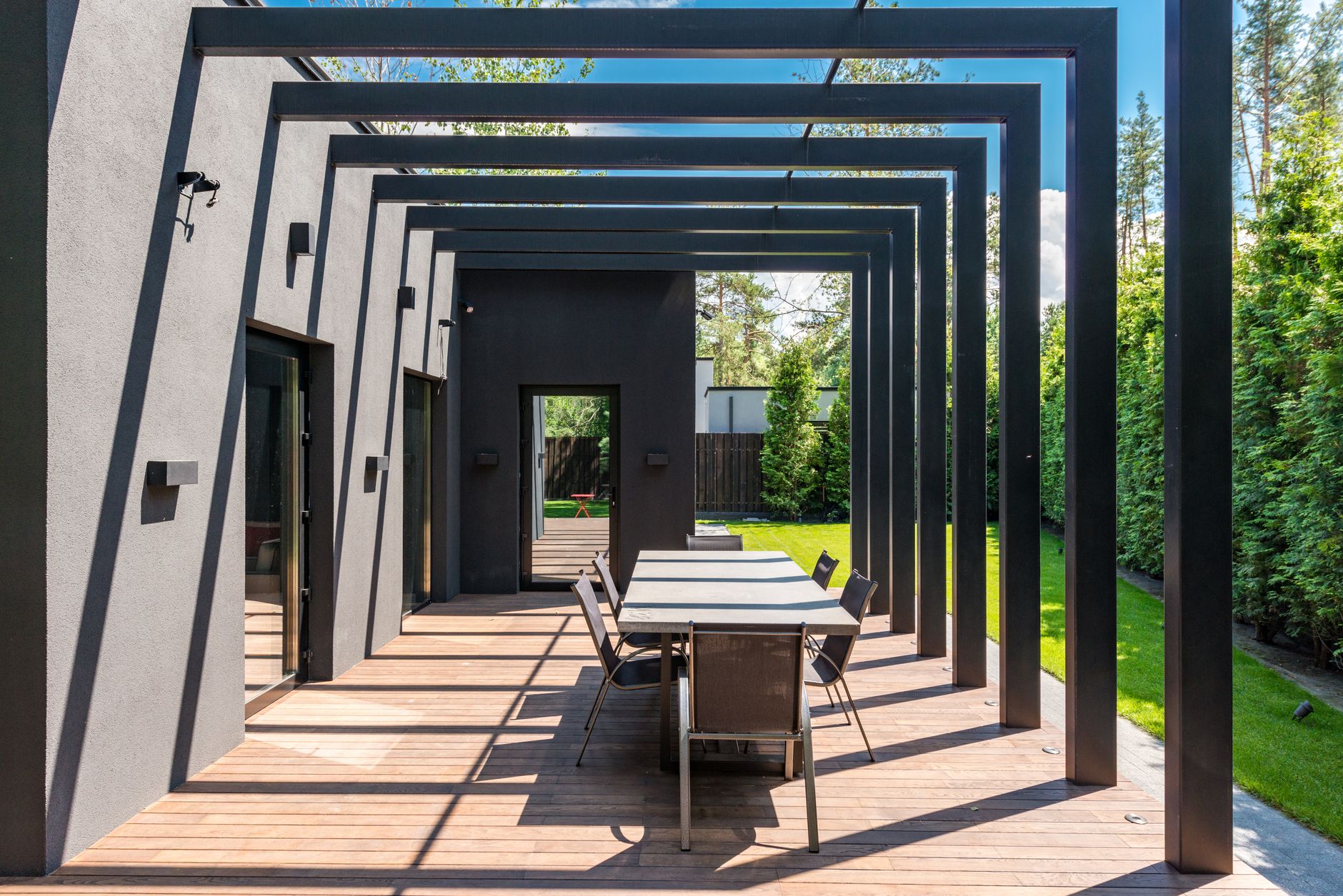 Covered outdoor patio with pergola and seating area